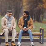 Midlife man sitting with a trusted friend, sharing a calm conversation