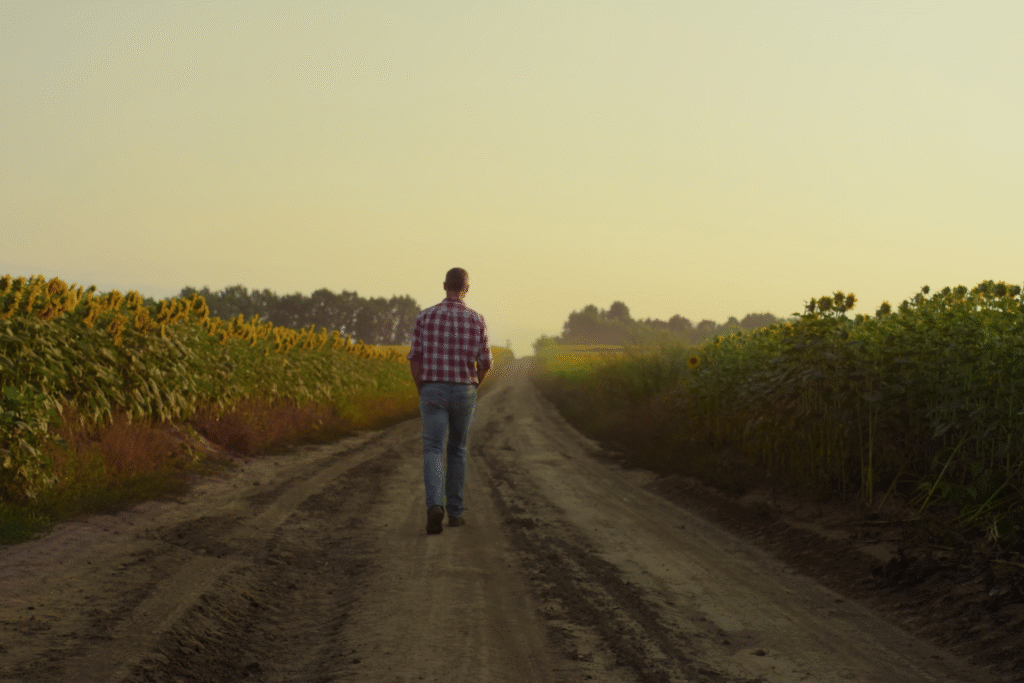Man walking thoughtfully along a quiet rural road
