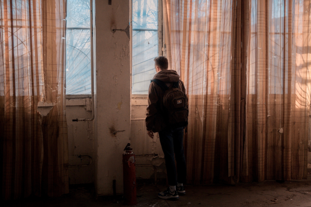 Man in midlife standing in doorway symbolizing identity transition and reinvention