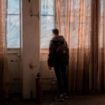Man in midlife standing in doorway symbolizing identity transition and reinvention