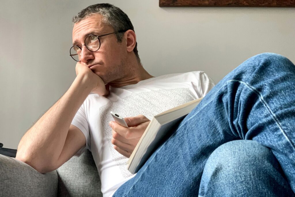 Person journaling and reflecting on emotional triggers as self-awareness practice